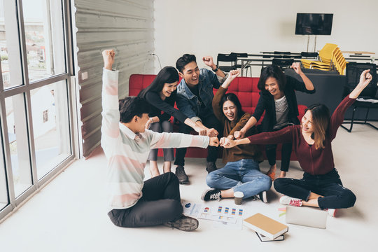 Young Successful Businesspeople Are Fist Bumping After Working Hard At New Project