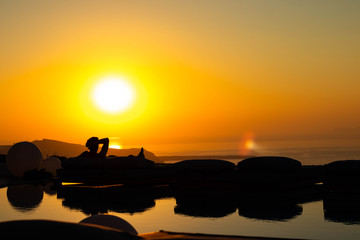 Silhouetted Man watching sunset, Santorini Greece