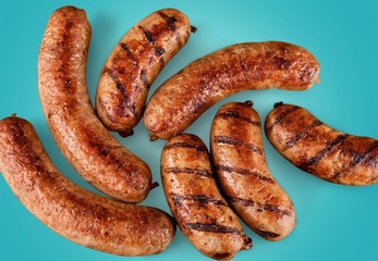 Roasted sausages on white background