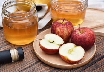 Apple cider vinegar on wooden board, Kombucha tea with apple slices, Healthy probiotic nutrition drink for good balance digestive system.