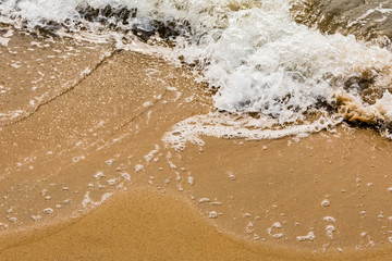A beautiful pattern of sea water form after collide sea water wave at sea shore. 