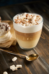 Cup of cappuccino coffee marshmallows on wooden table