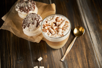 Cup of cappuccino coffee marshmallows on wooden table