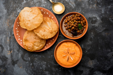 Suji/Sooji Halwa Puri or Shira Poori with black chana masala breakfast, served in a plate and bowl. selective focus - obrazy, fototapety, plakaty