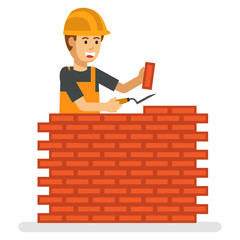 A happy construction worker working build the brick wall