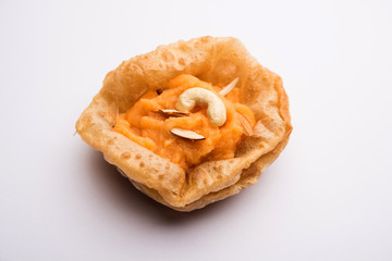 Suji/Sooji Halwa Puri or Shira Poori breakfast, served in a plate and bowl. selective focus