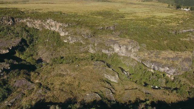 Aerial Pan Up The Rio Pita Valley To A Waterfall Flowing Over An Old Andesitic Lava Flow From Cotopaxi Volcano  In The Ecuadorian Andes. 