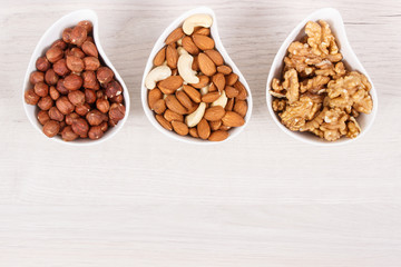 Various nuts and almonds as source healthy natural vitamins and minerals, place for inscription