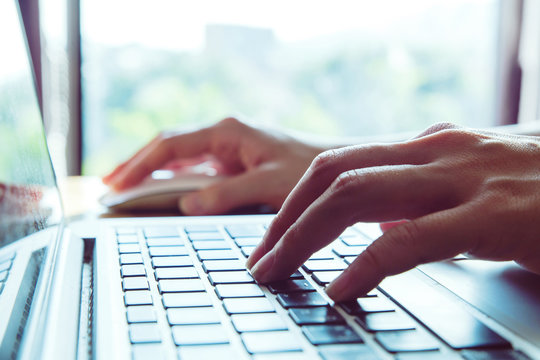 Close-up Of A Worker Using A Laptop Computer.pressing Buttons, Typing, Simple Close Up With Lens Flare