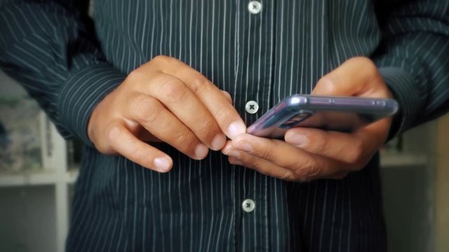 modern mobile phone in the hands of a man close up.