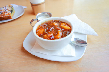 Swedish dried fruit soup, coffee, and pastry in a cafe for Swedish Fika, or coffee time