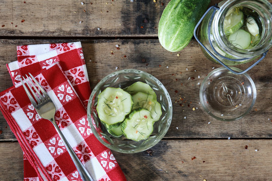 overhead flat lay image of cucumbers and ingredients to make refrigerator pickles
