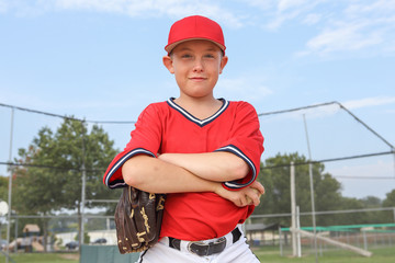 Boy pitcher smiling and holding a baseball © soupstock
