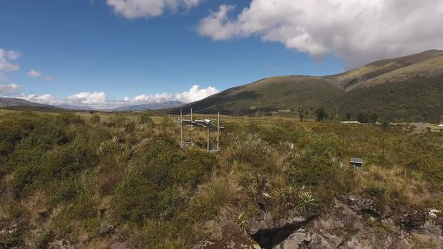Aerial shot of a solar powered monitoring station at the active Cotopaxi Volcano, Ecuador. The camera is pointing at the Rio Pita Valley to give early warning of lahars (debris flows).