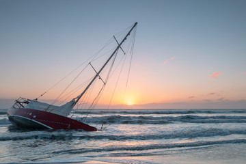 Sunken boat in first rays of light