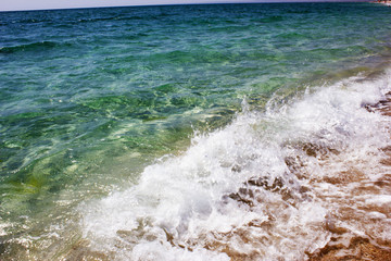 Sea in summer sunny weather. Clear water with the sea on the beach. Wave on the beach on the beach. Crystal clear water in the sea.