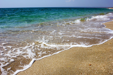 Sea in summer sunny weather. Clear water with the sea on the beach. Wave on the beach on the beach. Crystal clear water in the sea. 