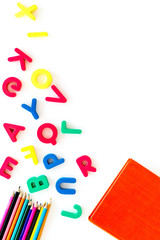 Children learn read concept. Hand hold plastic letters of toy alphabet on white background top view copy space