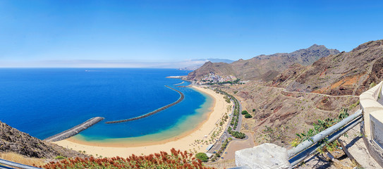 Panorama of Playa de Las Teresitas with turquoise water and gold sand located in near the village...