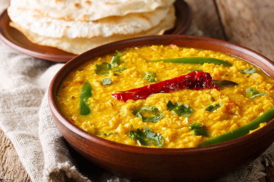 Spicy Indian thick soup Dal Tadka is a popular North Indian recipe close up in a bowl. Horizontal
