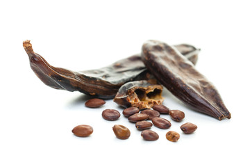 Carob on white background. Organic carob pods with seeds