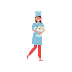 Cheerful woman holding glass cake stand with delicious cupcakes. Baker in uniform and hat. Flat vector design