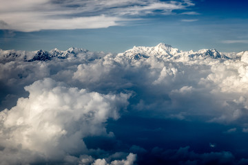 Fototapeta na wymiar Clouds against high mountains