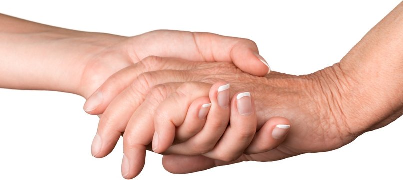 Young Woman's Hand Touching and Holding an Old Hand