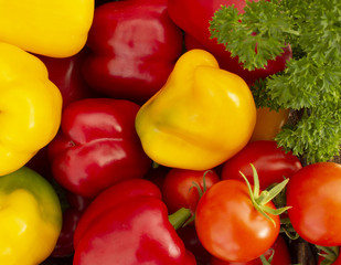 Background from bright multicolored vegetables. Peppers and Tomatoes