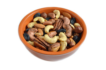 Nuts raisins in clay Cup on white isolate background