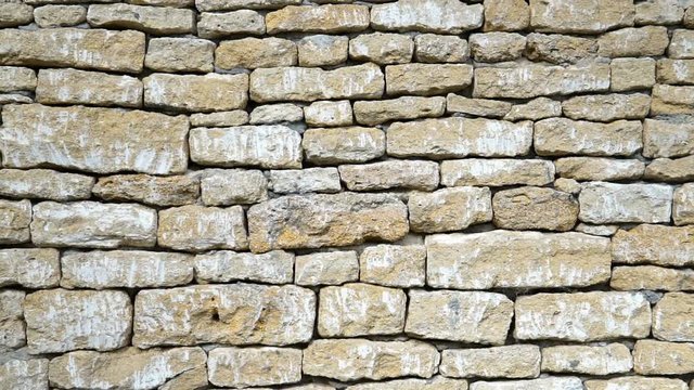 Texture of a stone wall. Old castle stone wall texture background. Stone wall as a background or texture. Camera moving.