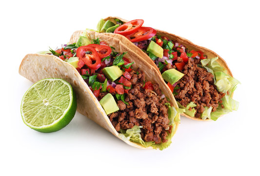 Mexican tacos with beef, tomatoes, avocado, chilli and onions isolated on white background.