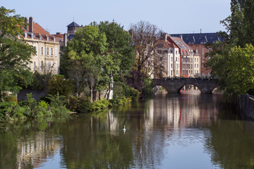 Fototapeta na wymiar French river in Metz in France in the summer day with some classic houses on the banks