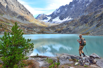 Fototapeta premium Altai territory, Ust-Koksinsky district, Russia. Tourist walking near Kuiguk (Kuyguk) lake