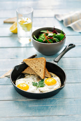 breakfast table Fried chicken eggs bread salad lemon water