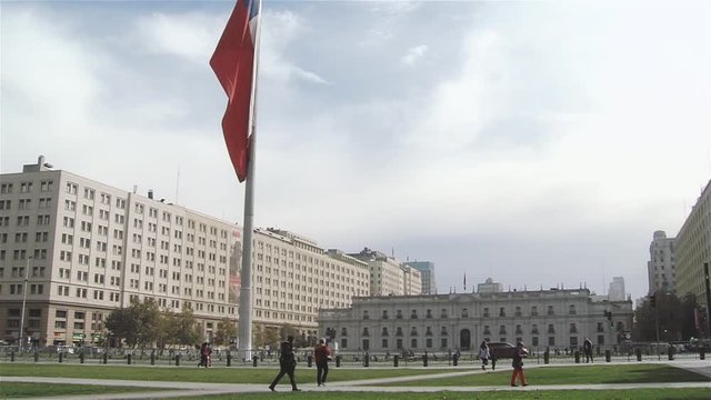 La Moneda Palace And Chile Flag, In Santiago De Chile.