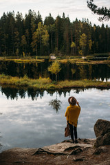 Young woman with hat at national park near lake