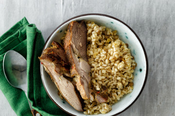 Healthy food porridge baked turkey meat bowl white wooden table top view