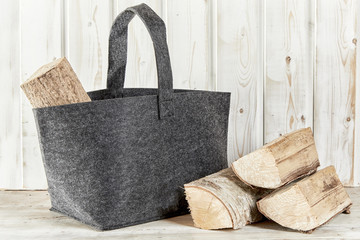 Rustic textile bag with chopped firewood - obrazy, fototapety, plakaty