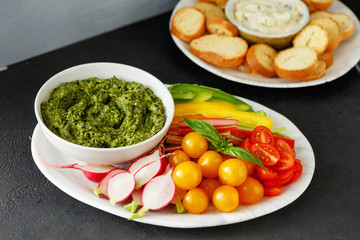 Vegetable snacks with pesto sauce served on plate