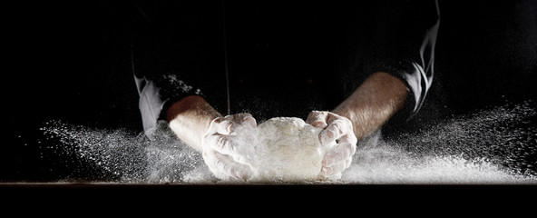 Cloud of flour caused by chef slamming dough