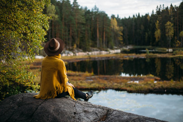 Young woman with hat at national park near lake