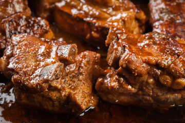 Pork spare ribs on dish in own sauce