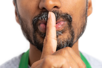 Close-up silence gesture made by hypermarket employee