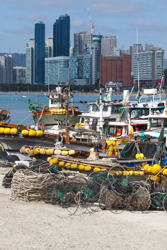 Cityscape of Busan with fishing boats