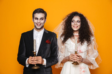 Happy couple dressed in scary Haloween costumes