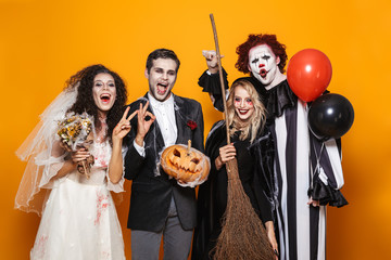 Group of friends dressed in scary costumes celebrating