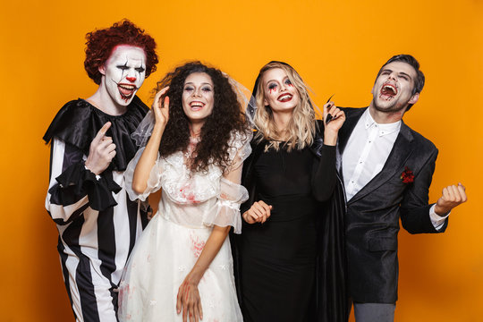 Group of laughing friends dressed in scary costumes