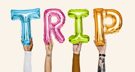 Hands showing trip balloons word