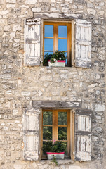 Old  stone house with  wooden shutters, Provence, France.
